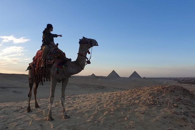 sunset at Giza pyramids by camels - Mounting the camels in the desert